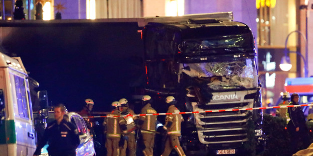 Police and emergency workers stand next to a crashed truck at the site of an accident at a Christmas market on Breitscheidplatz square near the fashionable Kurfuerstendamm avenue in the west of Berlin, Germany, December 19, 2016. REUTERS/Fabrizio Bensch
