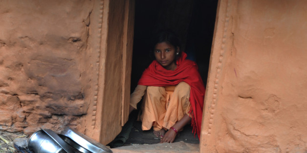 TO GO WITH Nepal-women-religion-society-chhaupadi,FEATURE by Frankie TaggartThirteen year old Nepalese villager Sarswati Biswo-Karma sits inside a 'chhaupadi house' in the village of Achham, some 800kms west of Kathmandu on November 23, 2011. Isolation is part of a centuries-old Hindu ritual known as chhaupadi which is blamed for prolongued depression, young women's deaths and high infant mortality rates in remote, impoverished western Nepal. Under the practice women are prohibited from partici