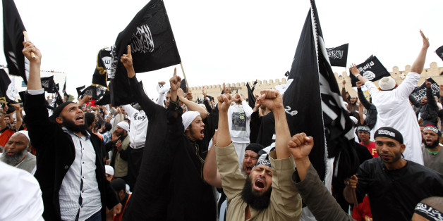 Tunisian Salafi Islamists wave flags inscribed with Islamic verses as they attend a rally in the central town of Kairouan May 20, 2012. Thousands of Salafis gathered on Kairouan on Sunday for the second national conference of Ansar al-Sharia,or Partisans of Islamic law, one of the most radical Salafi movements in the North African country. REUTERS/Anis Mili (TUNISIA - Tags: POLITICS CIVIL UNREST)