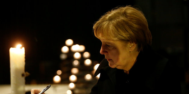 German Chancellor Angela Merkel signs the book of condolences on December 20, 2016 inside the Kaiser-Wilhelm-Gedaechtniskirche (Kaiser Wilhelm Memorial Church), the day after an attack at the nearby Christmas market in central Berlin.
German police said they were treating as 'a probable terrorist attack' the killing of 12 people when the speeding lorry cut a bloody swath through the packed Berlin Christmas market. / AFP / POOL / HANNIBAL HANSCHKE (Photo credit should read HANNIBAL HANSCHKE/AFP/Getty Images)
