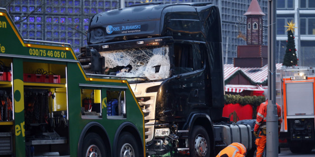 Rescue workers inspect the crashed truck at a Christmas market on Breitscheidplatz square near the fashionable Kurfuerstendamm avenue in the west of Berlin, Germany, December 20, 2016. REUTERS/Hannibal Hanschke