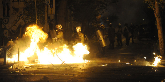 A petrol bomb explodes next to riot police during a demonstration against the visit of U.S President Barack Obama, in Athens, Greece, November 15, 2016. REUTERS/Michalis Karagiannis