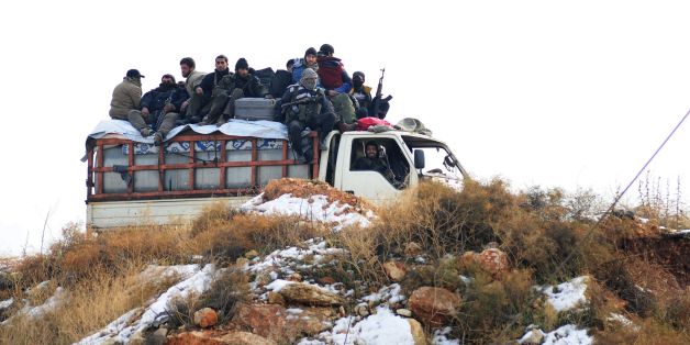 Syrian rebel fighters, are evacuated from Aleppo towards rebel-held territory in the west of Aleppo's province on December 22, 2016. / AFP / YOUSSEF KARWASHAN (Photo credit should read YOUSSEF KARWASHAN/AFP/Getty Images)