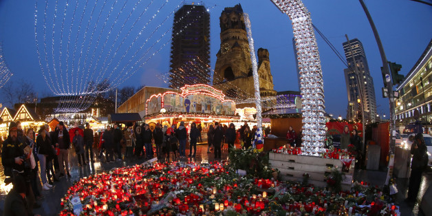 Flowers and candles are placed near the Christmas market at Breitscheid square in Berlin, Germany, December 22, 2016, following an attack by a truck which ploughed through a crowd at the market on Monday night. REUTERS/Fabrizio Bensch TPX IMAGES OF THE DAY