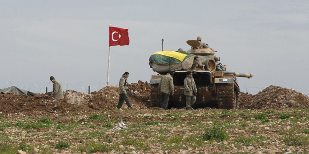 Turkish soldiers and an army tank take position at the new site of the Suleyman Shah tomb near the northern Syrian village of Esme, on the Syrian-Turkish border February 24, 2015. By extracting dozens of its soldiers surrounded by Islamist fighters in Syria, Turkey has warded off a potential crisis and shown its ability to manoeuvre between rival warring parties, including Islamic State. Several hundred Turkish ground troops, backed by tanks and drones, mounted an eight-hour operation on Saturday night to evacuate the 38 soldiers guarding the tomb of Suleyman Shah, grandfather of the founder of the Ottoman Empire. The fact there were no clashes appeared to suggest that Islamic State fighters surrounding the site were either warned or coerced by Turkey not to try to disrupt the incursion, the first it has mounted since Syria's civil war broke out in 2011. The Turkish Foreign Ministry said the tomb had been temporarily moved to a new site within Syria north of the village of Esme, close to the Turkish border. REUTERS/Stringer (TURKEY - Tags: POLITICS MILITARY CONFLICT TPX IMAGES OF THE DAY)