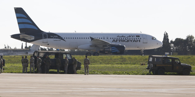 Maltese troops survey a hijacked Libyan Afriqiyah Airways Airbus A320 on the runway at Malta Airport, December 23, 2016. REUTERS/Darrin Zamit-Lupi MALTA OUT