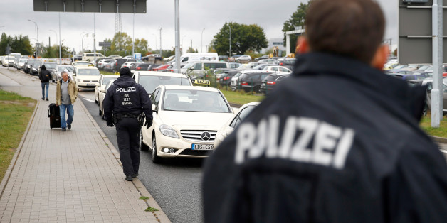 German policemen check cars on the entrance to Berlin-Schoenefeld airport, in Schoenefeld, near Berlin, October 9, 2016, following a suspicion that a bomb attack was being planned in Germany. REUTERS/Axel Schmidt