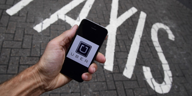 A photo illustration shows the Uber app logo displayed on a mobile telephone, as it is held up for a posed photograph in central London, Britain October 28, 2016. REUTERS/Toby Melville/Illustration