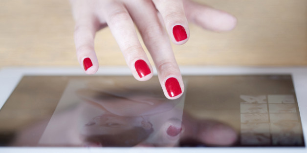 Woman's hands browsing on an electronic tablet.