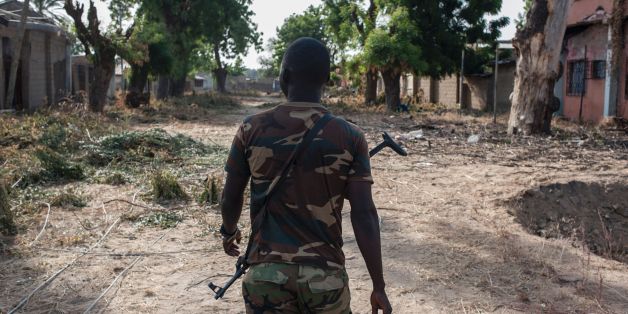 A nigerian soldier patrols in the streets of Bama in northeast Nigeria on December 8, 2016.
The houses are burnt-out shells, and charred cars and petrol pumps line the roads in the once-bustling Nigerian trade hub of Bama before it was razed by Boko Haram jihadists, know 85% is destroyed. The camp now houses a little over 10,000 people who either escaped or survived the seven months under Boko Haram rule. The conflict with Boko Haram in northeast Nigeria has displaced more than 2.6 million people. / AFP / STEFAN HEUNIS (Photo credit should read STEFAN HEUNIS/AFP/Getty Images)