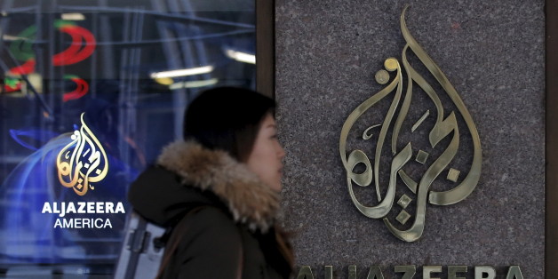A woman passes by the Al Jazeera America broadcast center in midtown Manhattan in New York City January 13, 2016. Al Jazeera America, the cable television news outlet owned by Qatar-based Al Jazeera Media Network, is shutting down less than three years after its high-profile launch, the network said on Wednesday. REUTERS/Brendan McDermid TPX IMAGES OF THE DAY