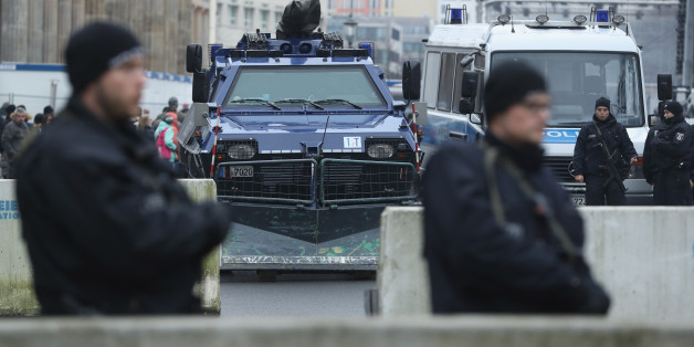 BERLIN, GERMANY - DECEMBER 23: Heavily-armed police stand behind concrete security barriers and a police armoured vehicle near the Brandenburg Gate prior to a concert there on December 23, 2016 in Berlin, Germany. German authorities remain on high alert following the shooting of terror suspect Anis Amri by Italian police in Milan. Amri, who is thought to be the driver who drove a truck into a Berlin Christmas market on December 19, killing 12 people and injuring dozens, possibly had accomplices
