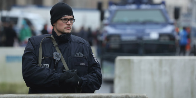 BERLIN, GERMANY - DECEMBER 23: A heavily-armed policeman stands behind concrete security barriers near a police armoured vehicle near the Brandenburg Gate prior to a concert there on December 23, 2016 in Berlin, Germany. German authorities remain on high alert following the shooting of terror suspect Anis Amri by Italian police in Milan. Amri, who is thought to be the driver who drove a truck into a Berlin Christmas market on December 19, killing 12 people and injuring dozens, possibly had acco