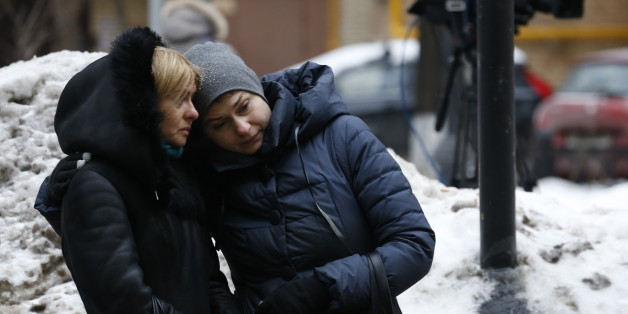 MOSCOW, RUSSIA - DECEMBER 25, 2016: Two women seen outside the Alexandrov Hall, a rehearsal room of the Alexandrov Ensemble, where Moscow residents bring flowers in memory of the victims of a Russian Defense Ministry plane crash. A Tupolev Tu-154 plane of the Russian Defense Ministry with 92 people on board crashed into the Black Sea near the city of Sochi on December 25, 2016. The plane was carrying members of the Alexandrov Ensemble, Russian servicemen and journalists to Russia's Hmeymim air b