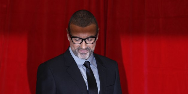 British singer George Michael poses for photographers before a news conference at the Royal Opera House in central London May 11, 2011. REUTERS/Stefan Wermuth (BRITAIN - Tags: ENTERTAINMENT)