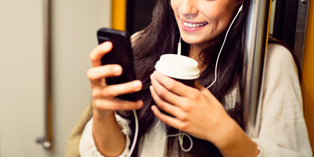 Young woman using a phone in subway train