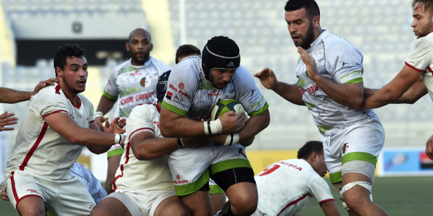 Algerian player (C) is tackled by Tunisian players during their friendly rugby match, Alegria's first international rugby match on home soil, on December 18, 2015 at the Stade Zabana in the Algerian coastal city of Oran. AFP PHOTO / FAROUK BATICHE / AFP / FAROUK BATICHE (Photo credit should read FAROUK BATICHE/AFP/Getty Images)