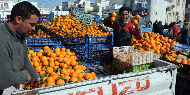 TO GO WITH AFP STORY BY Sonia BAKARICTunisian vendors sell oranges at the market in Ettadhamen, a popular city near Tunis on February 12, 2011. Mass protests sparked partly by poverty and unemployment resulted in Ben Ali's ouster on January 14, but public anxiety has remained. While the jobless rate is officially 14 per cent, the percentage of graduates out of work is double that. AFP PHOTO / FETHI BELAID (Photo credit should read FETHI BELAID/AFP/Getty Images)