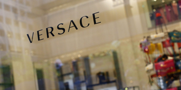 A sign is seen for high-end retail store Versace along 5th Avenue in New York May 19, 2013. Luxury spending in the United States collapsed after the 2008 financial crisis but roared back to pre-crisis levels by 2012. Sales in the Americas is expected to rise 5-7 percent this year, compared to 6-8 percent in mainland China and 0-2 percent in Europe, according to consultancy Bain & Co. Picture taken May 19, 2013. To match Insight LUXURY-US/ REUTERS/Eric Thayer (UNITED STATES - Tags: BUSINESS LOGO SOCIETY WEALTH)