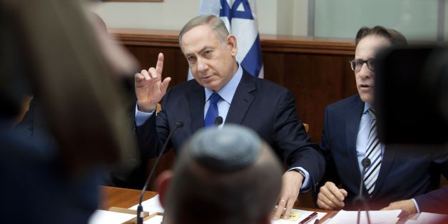 Israeli Prime Minister Benjamin Netanyahu chairs the weekly cabinet meeting in Jerusalem on December 25, 2016.Israel was defiant over a UN vote demanding it halt settlements in Palestinian territory, after lashing out at US President Barack Obama over the 'shameful' resolution. / AFP / AP AND POOL / Dan Balilty (Photo credit should read DAN BALILTY/AFP/Getty Images)