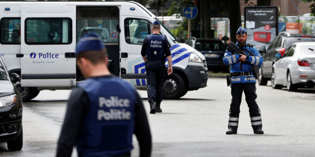 Belgian police officers stand guard near an apartment building during the reconstruction of the recent attacks, in the Brussels district of Etterbeek, Belgium, June 17, 2016. REUTERS/Francois Lenoir TPX IMAGES OF THE DAY