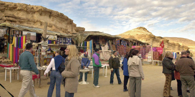 Tozeur, TUNISIA: Tourists visit a market in Tunisian Sahara city of Tozeur, 02 March 2006. Tourism is the leading sector of Tunisian economy AFP PHOTO FETHI BELAID (Photo credit should read FETHI BELAID/AFP/Getty Images)