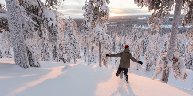 Young boy running on the deep snow.