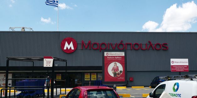 A customer stands outside the Greek Marinopoulos retail chain on June 29, 2016 after company filed for protection from its creditors, under the threat of confiscations.
Marinopoulos, Greeces biggest supermarket chain, is on the verge of bankruptcy. If its application is rejected some 12,500 employees will be left jobless and over 2,000 suppliers and creditors will lose money, creating an unprecedented situation in the Greek market. / AFP / LOUISA GOULIAMAKI (Photo credit should read LOUISA GOULIAMAKI/AFP/Getty Images)