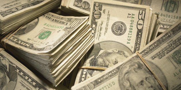 US Currency: Wads of US bills fastened with rubber bands, close-up