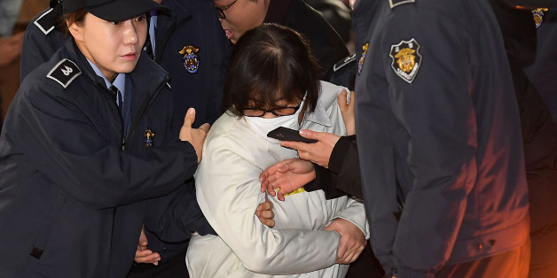 SEOUL, SOUTH KOREA - DECEMBER 24: Choi Soon-Sil (C), longtime confidante of the South Korean President Park Geun-hye, arrives for questioning into her suspected role in political scandal at the office of the independent counsel on December 24, 2016 in Seoul, South Korea. A South Korean Independent Counsel Team summoned Choi who allegedly exploited her connections with Park to extort money and favors from the country's largest companies and manipulate government affairs from the shadows. (Photo