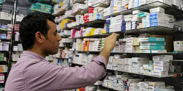 A pharmacist searches for medicine at a pharmacy in Cairo, Egypt, November 17, 2016. Picture taken November 17, 2016. REUTERS/Mohamed Abd El Ghany To match Insight EGYPT-CURRENCY/MEDICINE