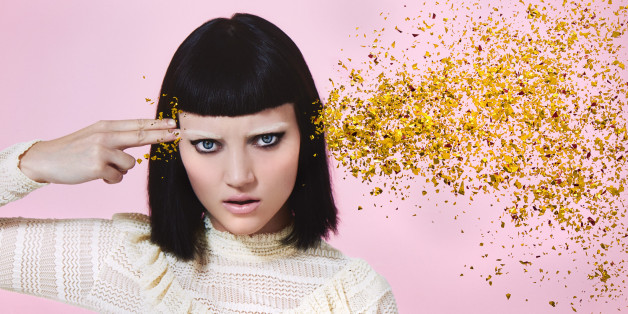 woman shooting glitter through head