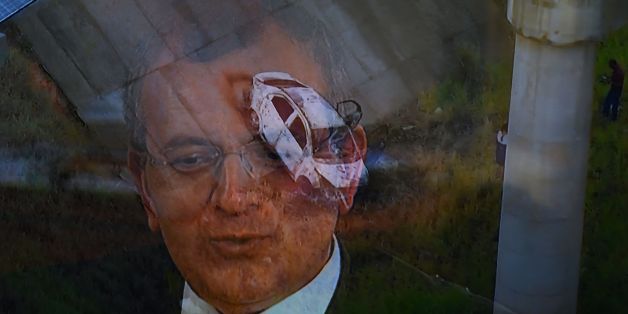 TV grab taken from TV Globo News showing the car and the face of Greek ambassador in Brazil, Kyriakos Amiridis in Nova Iguacu, Baixada Fluminense, Rio de Janeiro on December 30, 2016.
The car was found burned by police, under a bridge with an unidentified corpse inside. / AFP / VANDERLEI ALMEIDA (Photo credit should read VANDERLEI ALMEIDA/AFP/Getty Images)