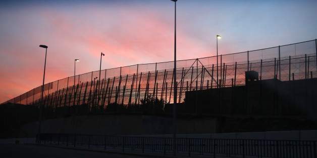 The border fence between Morocco and Spain's north African enclave Melilla is seen along a road, December 11, 2014. The conservative-led Spanish parliament passed an anti-protest bill on Thursday against heavy opposition from politicians and activist groups, who say the law violates the right to protest, limits freedom of expression and gives more power to police. The new bill includes tougher anti-immigration measures that will allow border police to deny entry to migrants from Africa trying to enter Spain by crossing fences at the enclaves Melilla and Ceuta. REUTERS/Juan Medina (SPAIN - Tags: POLITICS CRIME LAW SOCIETY IMMIGRATION)
