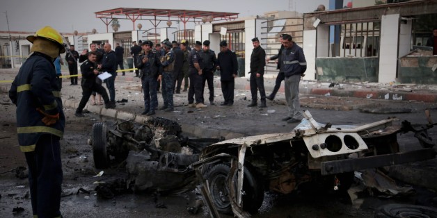BAGHDAD, IRAQ - DECEMBER 31 : A wreckage of a car is seen after a car bomb attack at el-Cedide street in Baghdad, Iraq on December 31, 2016. (Photo by Amir Saadi/Anadolu Agency/Getty Images)