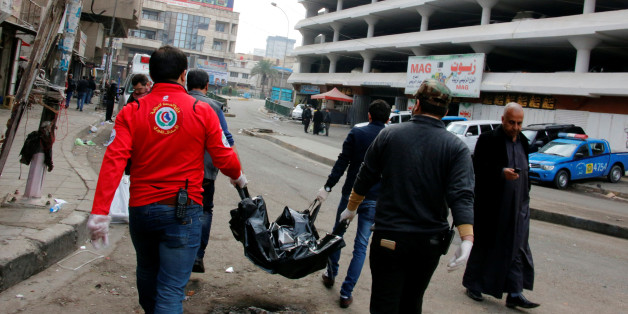 ATTENTION EDITORS - VISUALS COVERAGE OF SCENES OF INJURY OR DEATHMedical personnel carry the body of a victim at the site of a bomb attack at a market in central Baghdad, Iraq, December 31, 2016. REUTERS/Ali al-Mashhadani