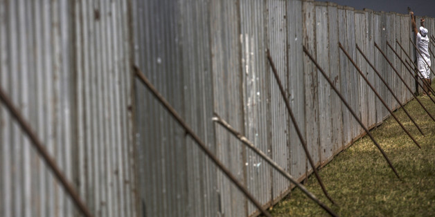 An inmate from a prison work program sets up a fence outside Congress in Brasilia, Brazil, on Friday, April 15, 2016. Brazil's lower house of Congress started a marathon session that will lead to a crucial impeachment vote on Sunday, following months of intense debate that has left Latin America's largest nation deeply divided. Photographer: Dado Galdieri/Bloomberg via Getty Images