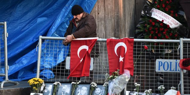 Baggage holders carry the coffin of one member of the Franco-Tunisian couple who were victims of an attack on a nightclub in the Turkish city of Istanbul on New Year's Eve following the arrival of their bodies at the Tunis-Carthage airport in the Tunisian capital on January 2, 2017. / AFP / FETHI BELAID (Photo credit should read FETHI BELAID/AFP/Getty Images)