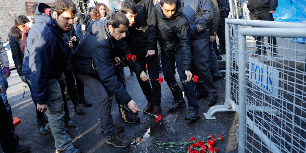 Men lay flowers outisde the Reina nightclub by the Bosphorus, which was attacked by a gunman, in Istanbul, Turkey, January 1, 2017. REUTERS/Umit Bektas