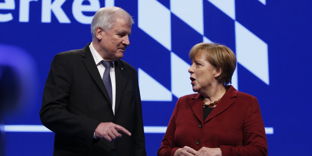 Bavarian Prime Minister and head of the Christian Social Union (CSU) Horst Seehofer welcomes German Chancellor Angela Merkel to the Christian Social Union (CSU) party congress in Munich, Germany November 20, 2015. REUTERS/Michael Dalder