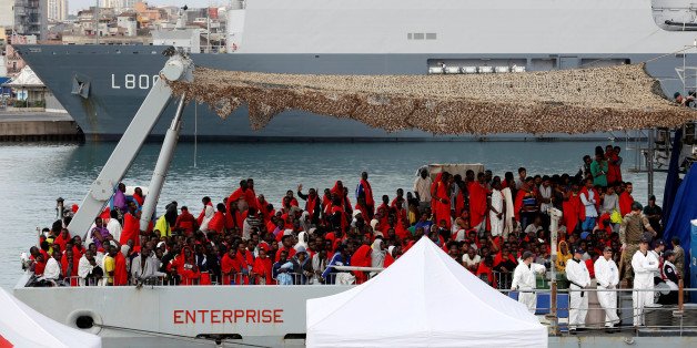 Migrants wait for disembark from Royal Navy Ship HMS Enterprise in the Sicilian harbour of Catania, Italy, October 23, 2016. REUTERS/Antonio Parrinello