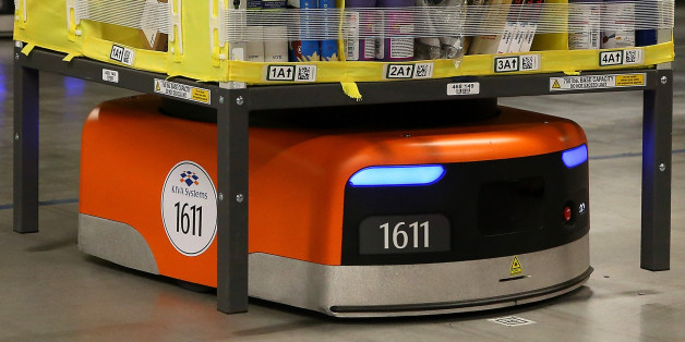 TRACY, CA - JANUARY 20: A Kiva robot moves a rack of merchandise at an Amazon fulfillment center on January 20, 2015 in Tracy, California. Amazon officially opened its new 1.2 million square foot fulfillment center in Tracy, California that employs more than 1,500 full time workers as well as 3,000 Kiva robots that can fetch merchandise for workers and are capable of lifting up to 750 pounds. Amazon is currently using 15,000 of the robots spread over 10 fulfillment centers across the country. (Photo by Justin Sullivan/Getty Images)