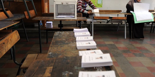 Algerian election commission officials wait for voters in a classroom turned into a polling station in Algiers on April 17, 2014. President-candidate Abdelaziz Bouteflika, seeking a fourth presidential term, casted his ballot from a wheelchair as Algerians voted in an election he is widely expected to win despite chronic health problems. AFP PHOTO / FAROUK BATICHE (Photo credit should read FAROUK BATICHE/AFP/Getty Images)