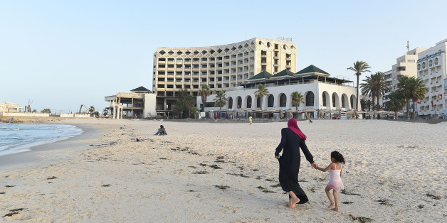 SOUSSE, TUNISIA - JUNE 22: A young woman walks along the beach front in front of the once popular but now closed down Hotel Boujafar in Sousse in the north of Tunisia where the country's tourism industry has fallen into a steep decline since last year's terror attacks, on June 22, 2016 in Tunis, Tunisia. One year ago, on 26th June 2015, a radicalised Tunisian student, Seifeddine Rezgui, killed 38 people in a terrorist attack on the beaches of the popular holiday resort of Sousse leading the Brit