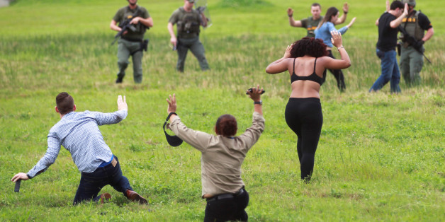 Law enforcement officers move in to verify the identity of people in this field just outside the airport perimeter following a shooting incident at Fort Lauderdale-Hollywood International Airport in Fort Lauderdale, Florida, U.S. January 6, 2017. REUTERS/Andrew Innerarity TPX IMAGES OF THE DAY