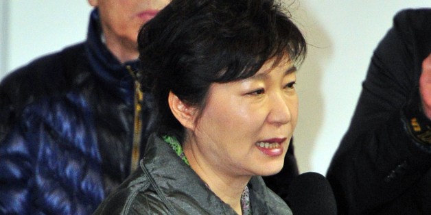 South Korea's President Park Geun-Hye (C) speaks during a visit to relatives of missing passengers on board a capsized ferry as they wait for updates about their loved ones at a gym in Jindo on April 17, 2014. Rescuers worked frantically on April 17 to find 300 people -- mostly schoolchildren -- missing after a South Korean ferry capsized, with prospects of pulling survivors from the submerged vessel dimming as emotions boiled over among anguished relatives. AFP PHOTO / JUNG YEON-JE