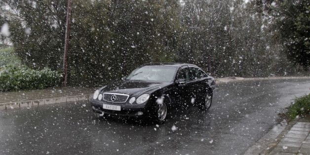 LARNACA, CYPRUS - 2015/02/19: A car passing by the snowing road in Nicosia, Cyprus. Due to bad weather conditions, snow was experienced for the first time since 1996 at Larnaca and other areas in Cyprus. (Photo by Yiorgos Doukanaris/Pacific Press/LightRocket via Getty Images)
