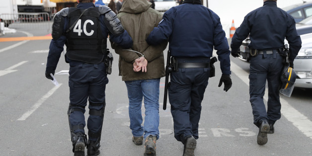 French police escort a man who was apprehended after farmers destroyed the French Ministry of Agriculture information booth on the opening day of the International Agricultural Show in Paris, France, February 27, 2016. French farmers protested during an early morning visit by France's President Hollande. The Paris Farm Show runs from February 27 to March 6, 2016. REUTERS/Benoit Tessier ATTENTION EDITORS FRENCH LAW REQUIRES THAT HANDCUFFS OR RESTRAINTS ARE MASKED IN PUBLICATIONS WORLDWIDE