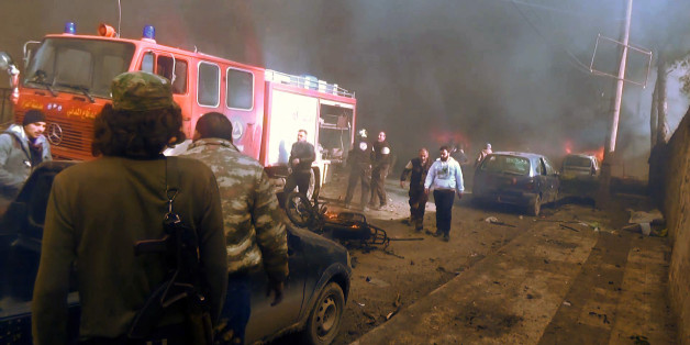 An image grab taken from an AFPTV video released on January 7, 2017 shows people gathering amidst the debris at the site of a car bomb attack in the rebel-held town of Azaz in northern Syria.
According to the Syrian Observatory for Human Rights, at least 43 people were killed and dozens injured in the blast that ripped through the town near the Turkish border.
/ AFP / AFPTV / STRINGER (Photo credit should read STRINGER/AFP/Getty Images)