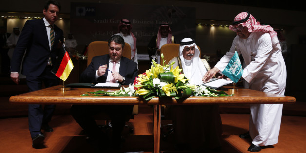 German Economy Minister deputy chancellor Sigmar Gabriel (seated L) and Saudi Finance Minister Ibrahim al-Assaf (seated R) sign an economic agreement in Riyadh March 8, 2015. REUTERS/Faisal AlNasser (SAUDI ARABIA - Tags: SOCIETY)